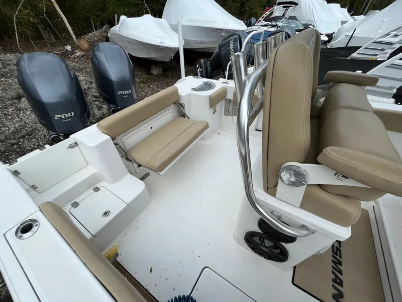 Slide: The Image of 2017 Sportsman 252 boat interior with dual engines and beige seating. - 19