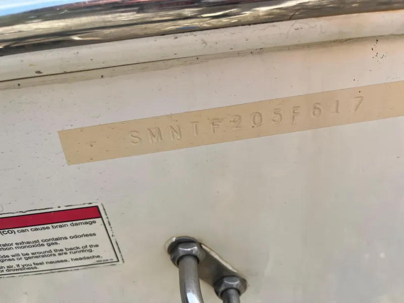 Slide: The Image of Hull identification number on 2017 Sportsman 252 boat, with safety warning label. - 21