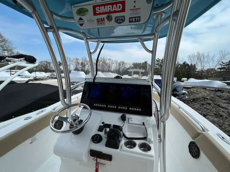 Slide: The Image of 2017 Sportsman 252 boat dashboard with steering wheel and navigation equipment. - 24