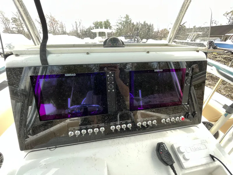 Slide: The Image of 2017 Sportsman 252 boat dashboard with dual Simrad displays and control panel. - 25