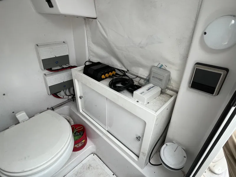 Slide: The Image of Interior of a 2017 Sportsman 252 boat with toilet and storage area. - 30