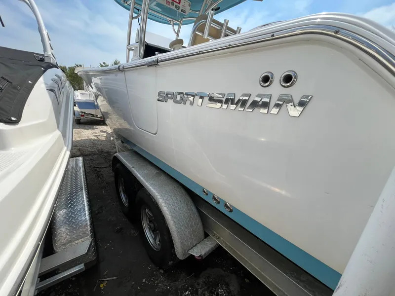 Slide: The Image of 2017 Sportsman 252 boat on trailer, side view with logo visible. - 4