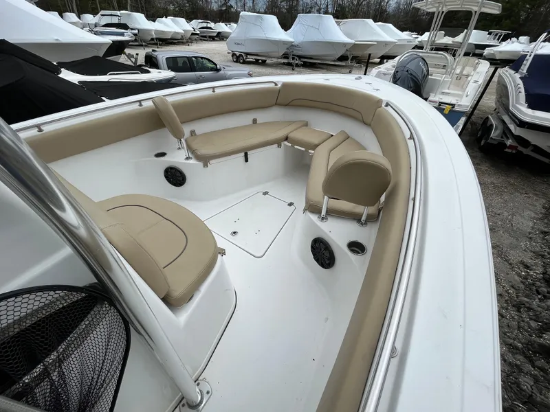 Slide: The Image of 2017 Sportsman 252 boat with beige seating, docked among covered boats. - 7