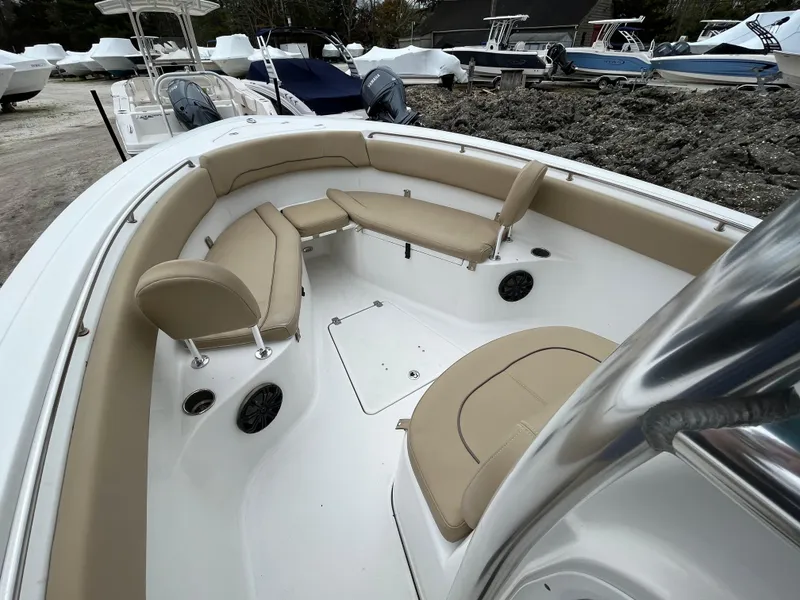 Slide: The Image of 2017 Sportsman 252 boat interior with beige seating and white deck. - 8