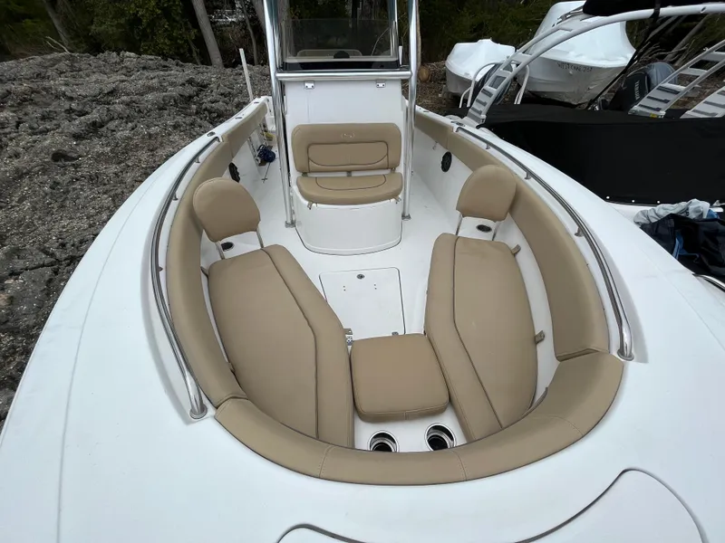 Slide: The Image of 2017 Sportsman 252 boat interior with tan seating and white deck. - 9