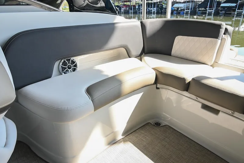 Slide: The Image of 2021 Crownline 265 SS boat interior with cushioned seating and speaker. - 13