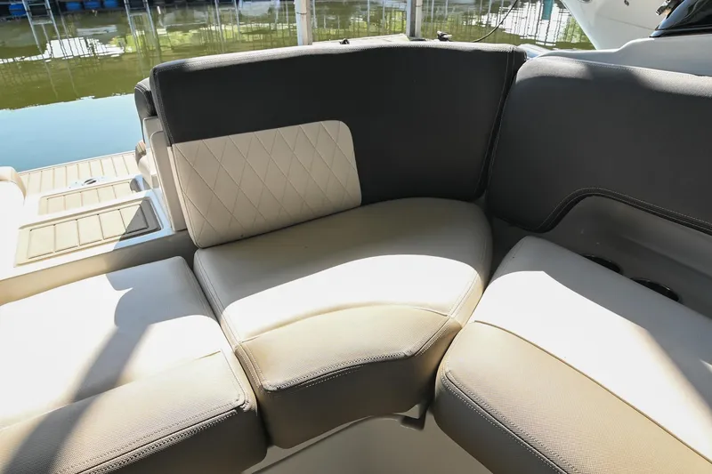 Slide: The Image of 2021 Crownline 265 SS boat interior seating with beige and gray upholstery. - 16