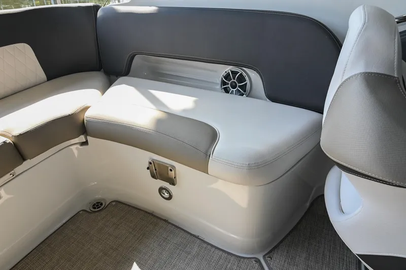 Slide: The Image of 2021 Crownline 265 SS boat interior with cushioned seating and speaker. - 17
