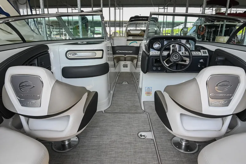 Slide: The Image of Interior of a 2021 Crownline 265 SS boat, featuring modern seating and dashboard. - 18