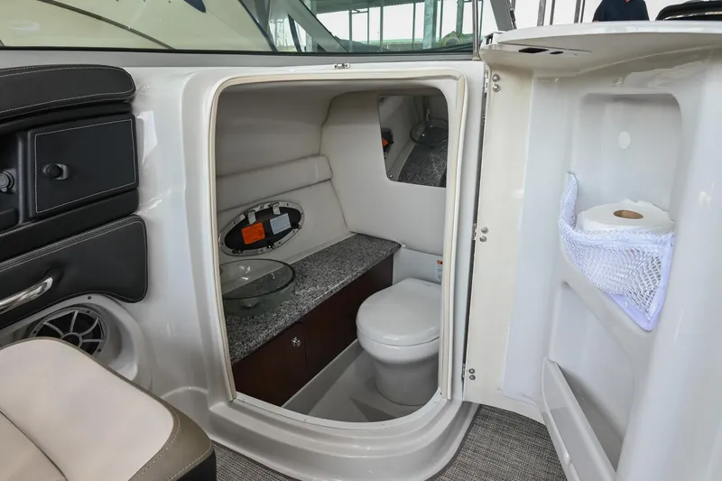 Slide: The Image of 2021 Crownline 265 SS boat interior with compact bathroom and modern amenities. - 21