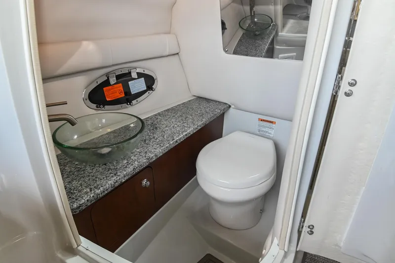 Slide: The Image of 2021 Crownline 265 SS boat bathroom with modern sink and toilet. - 22