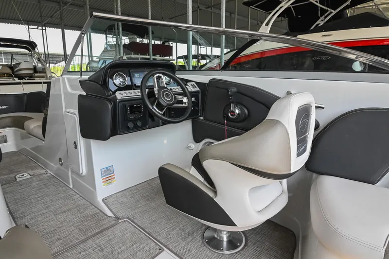 Slide: The Image of 2021 Crownline 265 SS boat interior with modern dashboard and comfortable seating. - 24