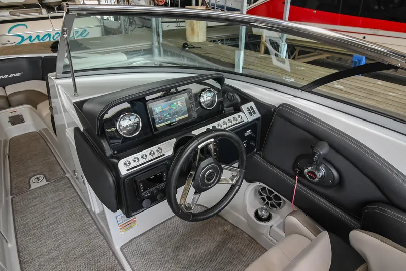 Slide: The Image of 2021 Crownline 265 SS boat interior with modern dashboard and steering wheel. - 26