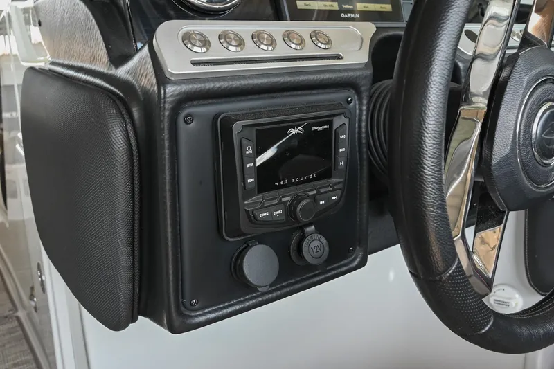 Slide: The Image of Dashboard of 2021 Crownline 265 SS boat with steering wheel and control panel. - 29