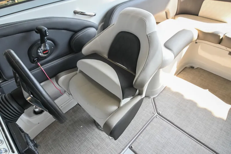 Slide: The Image of 2021 Crownline 265 SS boat interior with steering wheel and seating area. - 30