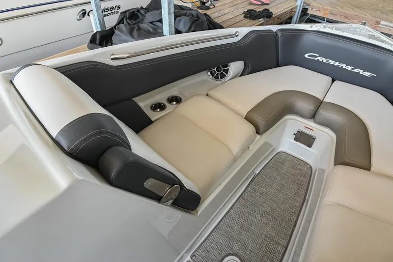 Slide: The Image of 2021 Crownline 265 SS boat interior with cushioned seating and cup holders. - 33