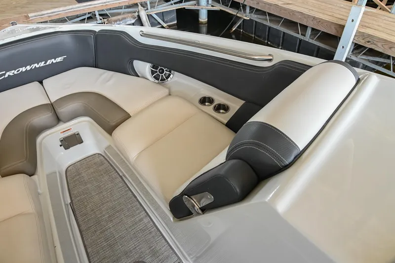 Slide: The Image of 2021 Crownline 265 SS boat interior with beige and black seating, cup holders, and speaker. - 34