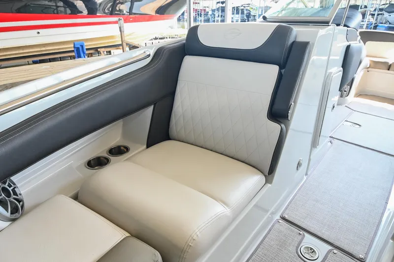 Slide: The Image of 2021 Crownline 265 SS boat interior with luxurious seating and cup holders. - 35