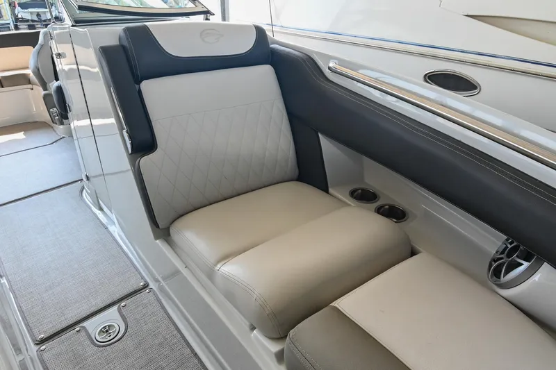 Slide: The Image of 2021 Crownline 265 SS boat interior with cushioned seating and cup holders. - 36