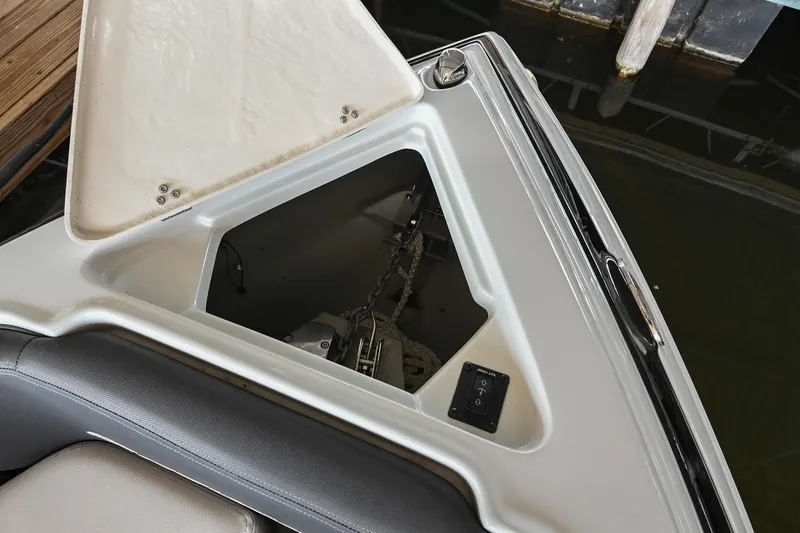 Slide: The Image of 2021 Crownline 265 SS boat anchor compartment with open hatch. - 38
