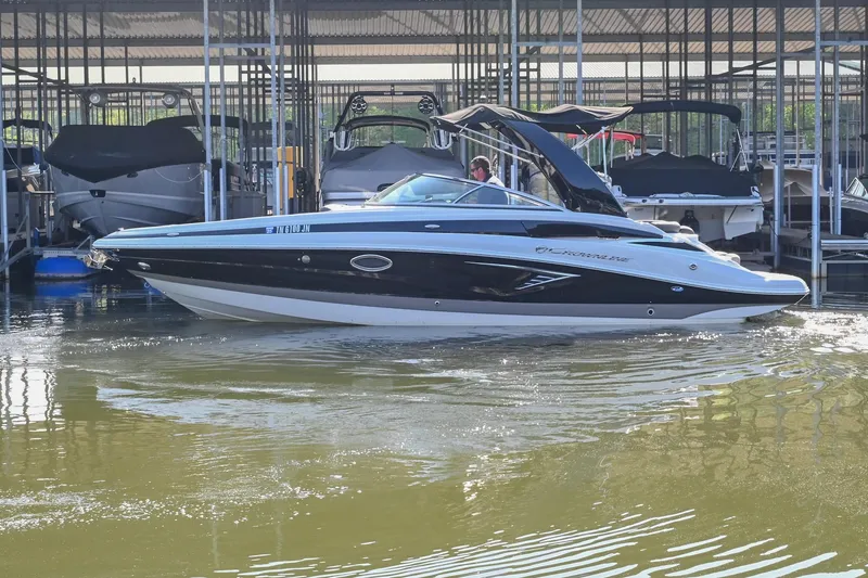 Slide: The Image of 2021 Crownline 265 SS boat docked in marina, side view. - 5