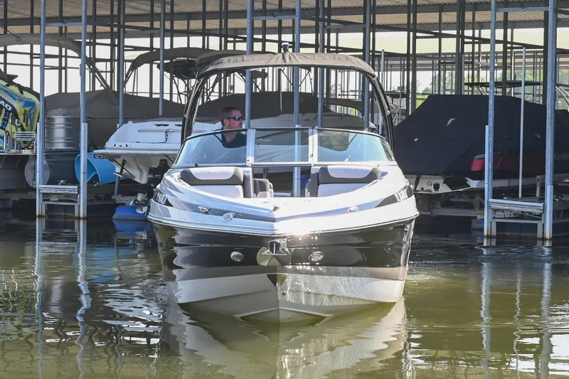 Slide: The Image of 2021 Crownline 265 SS boat docked in marina, front view. - 6