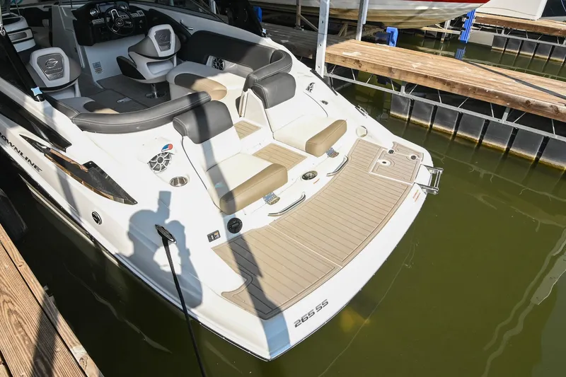 Slide: The Image of 2021 Crownline 265 SS boat docked, featuring spacious seating and modern design. - 8