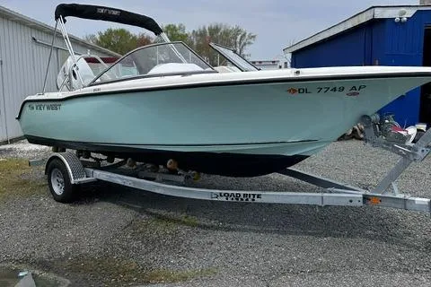 Slide: The Image of 2024 Key West 203 DFS boat on trailer, parked outdoors near buildings. - 1