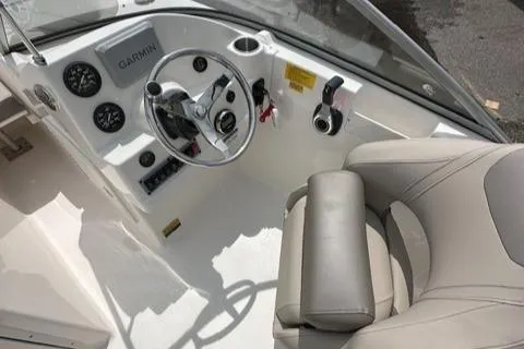 Slide: The Image of 2024 Key West 203 DFS boat cockpit with steering wheel, Garmin display, and comfortable seating. - 10