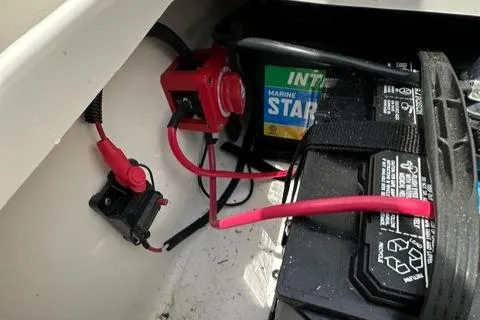 Slide: The Image of Battery compartment of 2024 Key West 203 DFS boat with marine battery and wiring. - 14