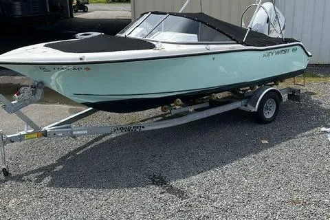 Slide: The Image of 2024 Key West 203 DFS boat on trailer, parked outdoors, with black cover. - 3