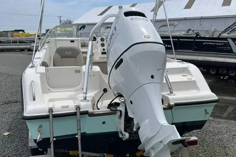 Slide: The Image of 2024 Key West 203 DFS boat with outboard motor, docked in a marina. - 4