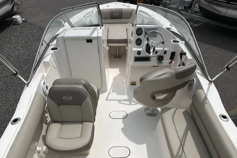 Slide: The Image of 2024 Key West 203 DFS boat interior with seating and steering console. - 9