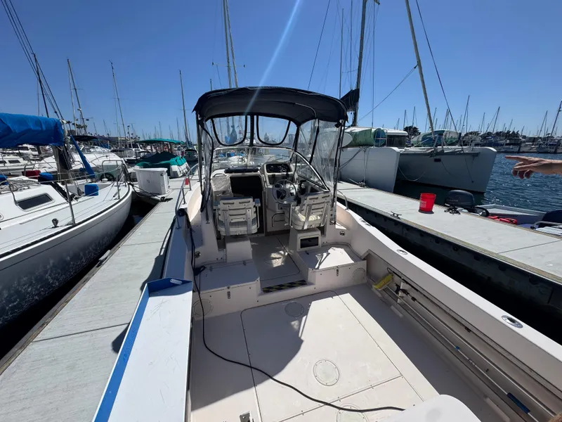 Slide: The Image of 1996 Grady-White Voyager 248 boat docked at marina under clear blue sky. - 3