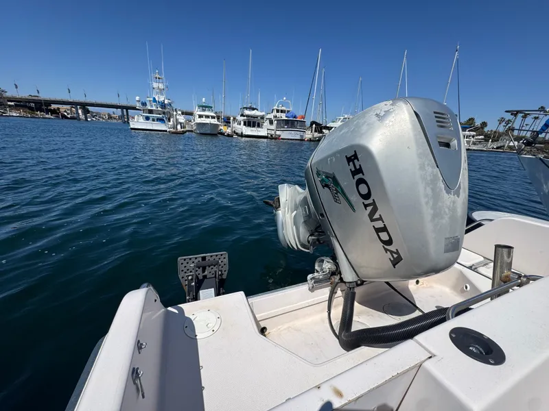 Slide: The Image of Grady-White Voyager 248 boat with Honda outboard motor, docked in a marina, 1996 model. - 7