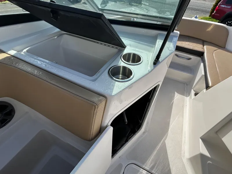 Slide: The Image of 2021 Sea Ray SPX 210 OB interior with cup holders and seating area. - 13