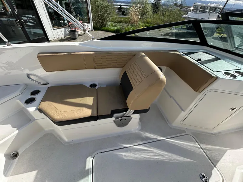 Slide: The Image of 2021 Sea Ray SPX 210 OB boat interior with tan seating and cup holders. - 8