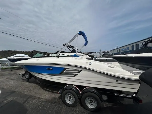 Slide: The Image of 2015 Sea Ray 21 SPX boat on trailer, blue and white design, parked outdoors. - 3