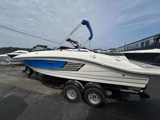 Slide: The Image of 2015 Sea Ray 21 SPX boat on trailer, blue and white design, parked outdoors. - 4