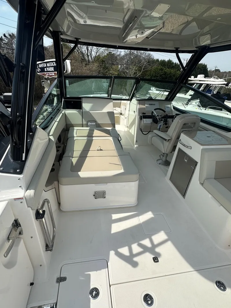 Slide: The Image of 2025 Boston Whaler 280 Vantage boat interior with seating and helm, showcasing modern design. - 10