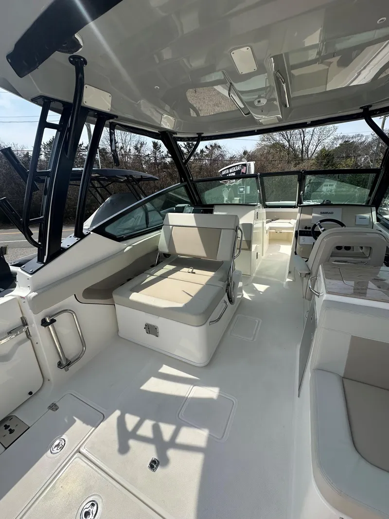 Slide: The Image of 2025 Boston Whaler 280 Vantage interior with seating and helm, showcasing modern design. - 11