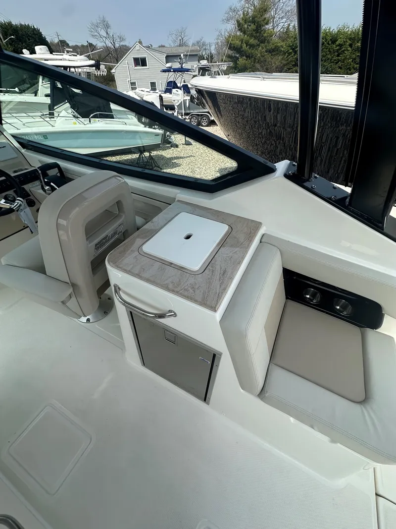 Slide: The Image of 2025 Boston Whaler 280 Vantage boat interior with seating and storage. - 14