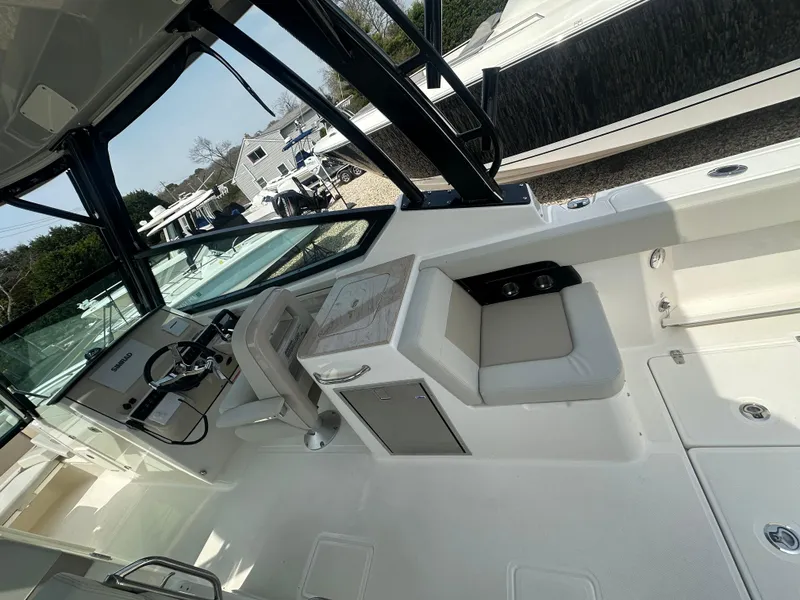 Slide: The Image of 2025 Boston Whaler 280 Vantage boat interior with helm and seating area. - 17