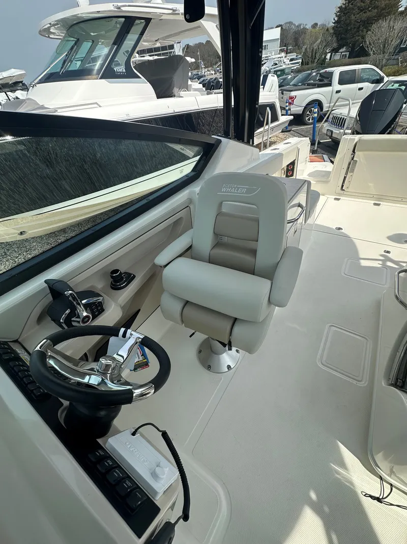 Slide: The Image of 2025 Boston Whaler 280 Vantage boat interior with helm and captain's chair. - 19