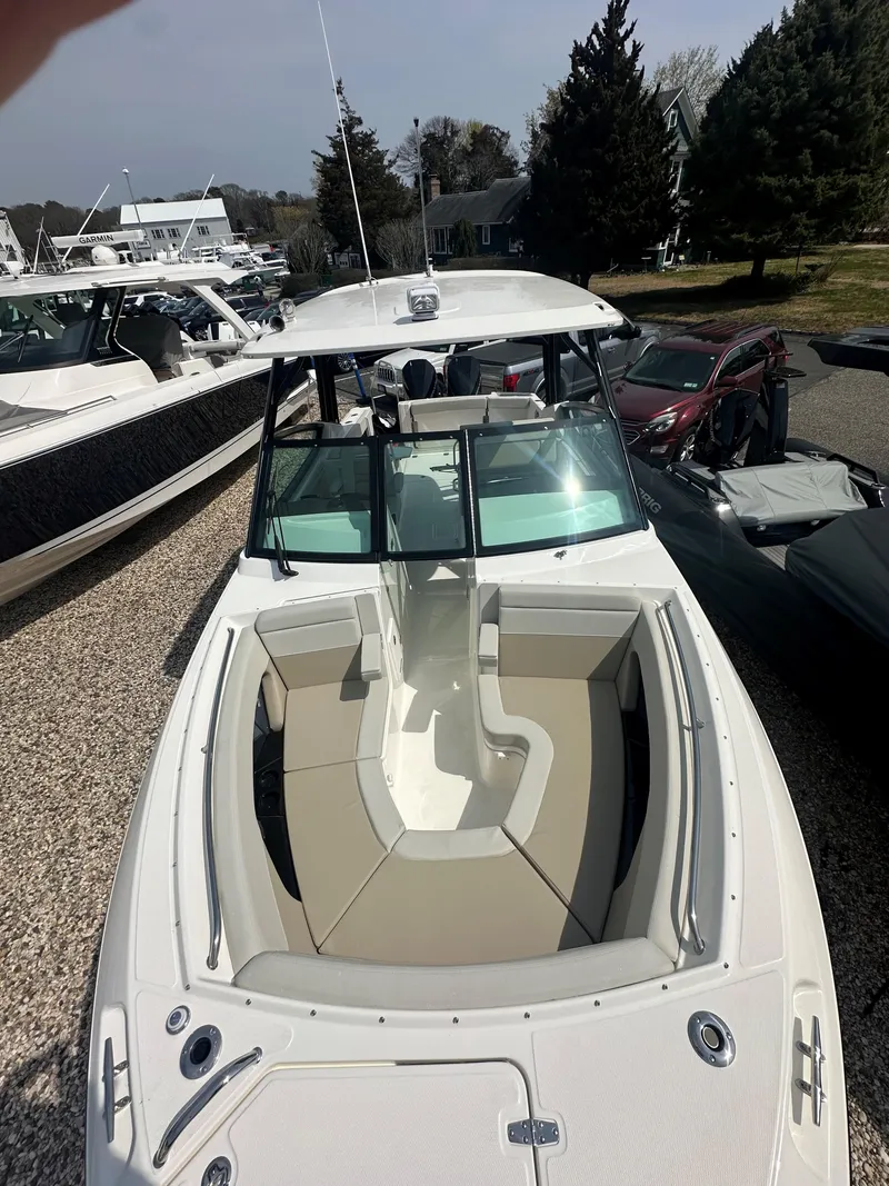 Slide: The Image of 2025 Boston Whaler 280 Vantage boat with spacious seating, docked outdoors. - 20