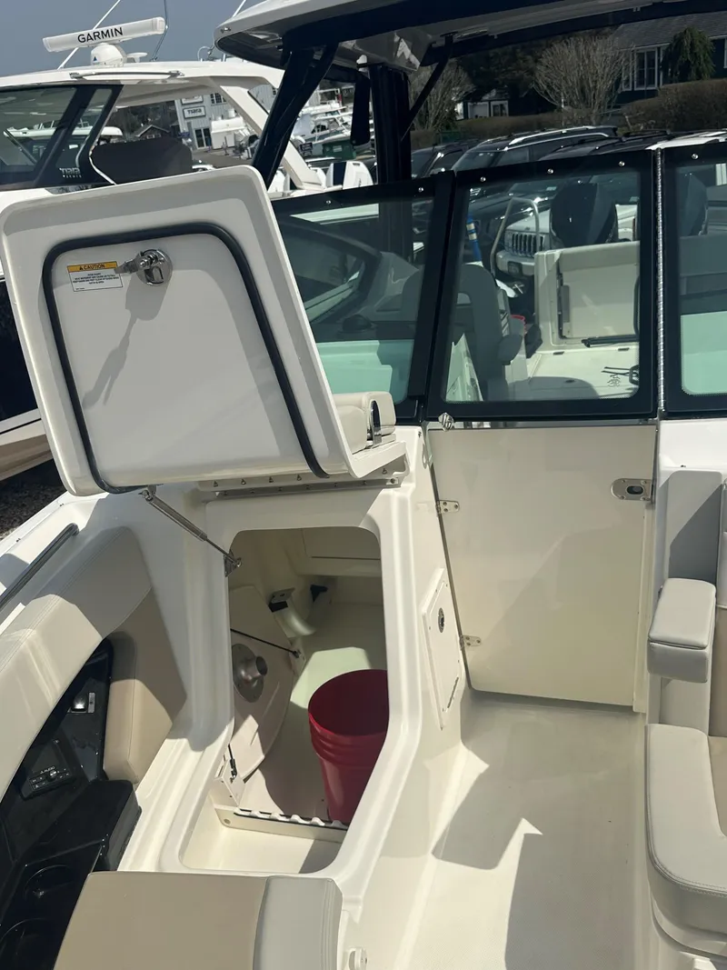 Slide: The Image of 2025 Boston Whaler 280 Vantage boat interior with open storage compartment. - 23