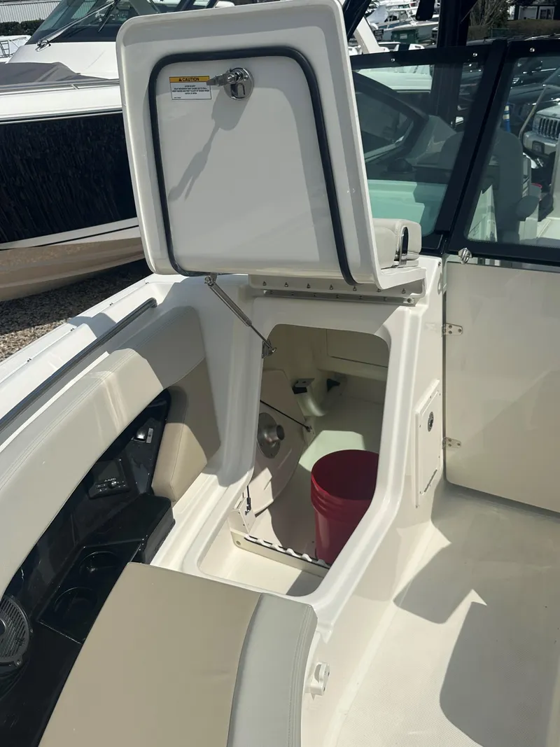 Slide: The Image of 2025 Boston Whaler 280 Vantage boat interior with open storage compartment. - 25