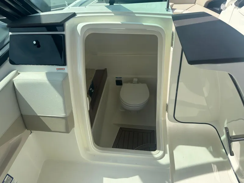 Slide: The Image of 2025 Boston Whaler 280 Vantage boat interior with compact marine toilet. - 26