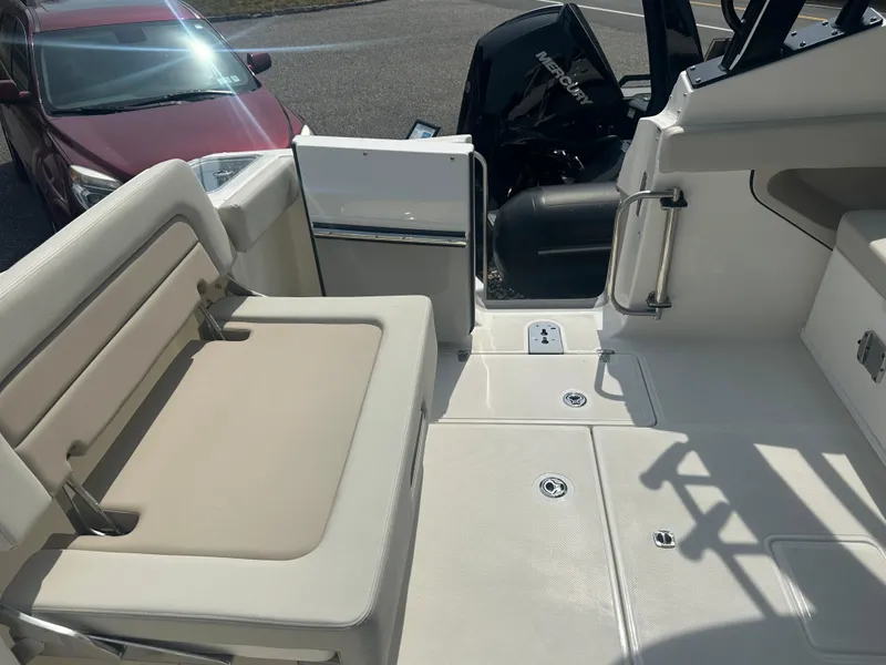 Slide: The Image of 2025 Boston Whaler 280 Vantage boat interior with seating and engine view. - 7