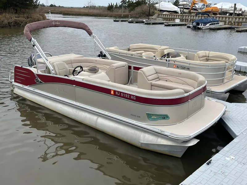 Slide: The Image of 2014 Avalon CATALINA 22 pontoon boat docked on a calm lake. - 1